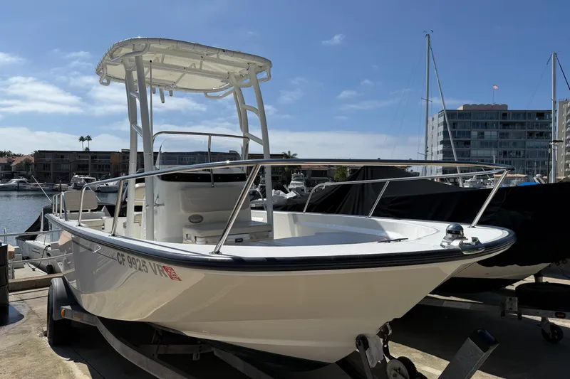 Slide: The Image of 2019 Boston Whaler 190 Montauk boat with Mercury engine on trailer at marina. - 8