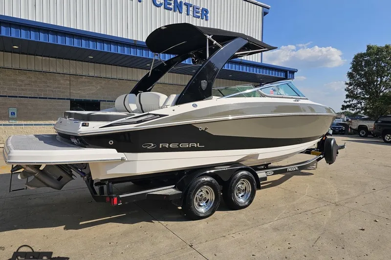 Slide: The Image of 2018 Regal 2500 Bowrider boat on trailer outside a building, sunny day. - 10
