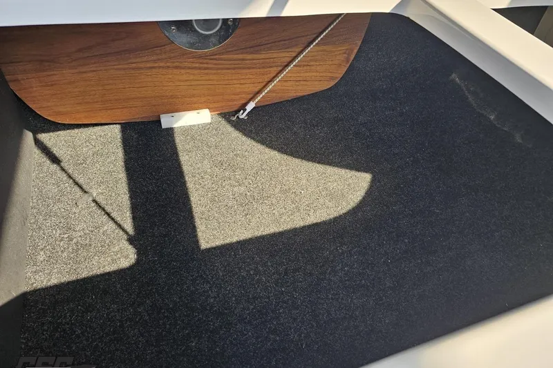 Slide: The Image of Interior storage compartment of 2018 Regal 2500 Bowrider boat with carpeted flooring. - 101