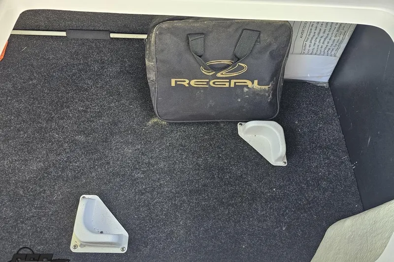 Slide: The Image of Storage compartment of a 2018 Regal 2500 Bowrider with a branded bag. - 103