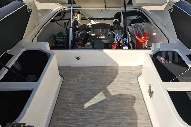Slide: The Image of 2018 Regal 2500 Bowrider engine compartment with storage and equipment. - 104
