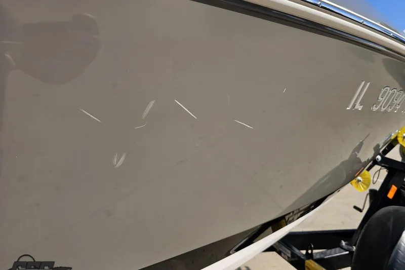 Slide: The Image of 2018 Regal 2500 Bowrider with visible scratches on the hull, parked on a trailer. - 13