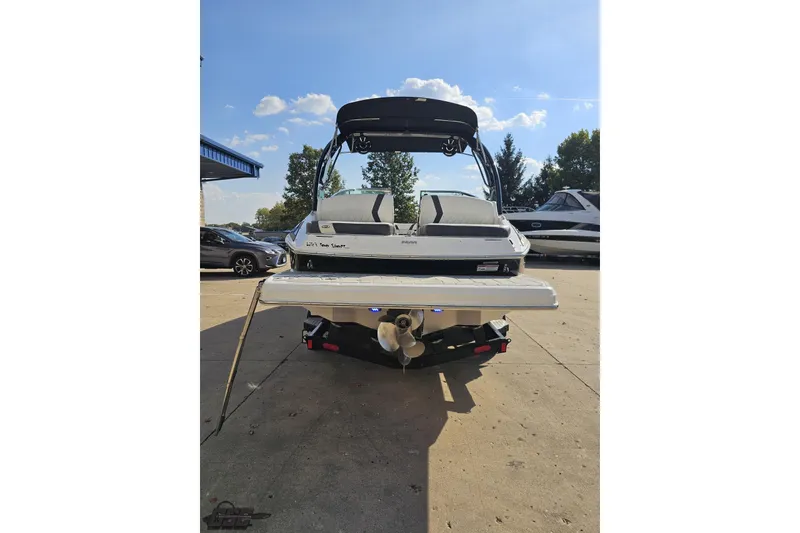 Slide: The Image of 2018 Regal 2500 Bowrider boat, rear view, parked outdoors on a sunny day. - 29
