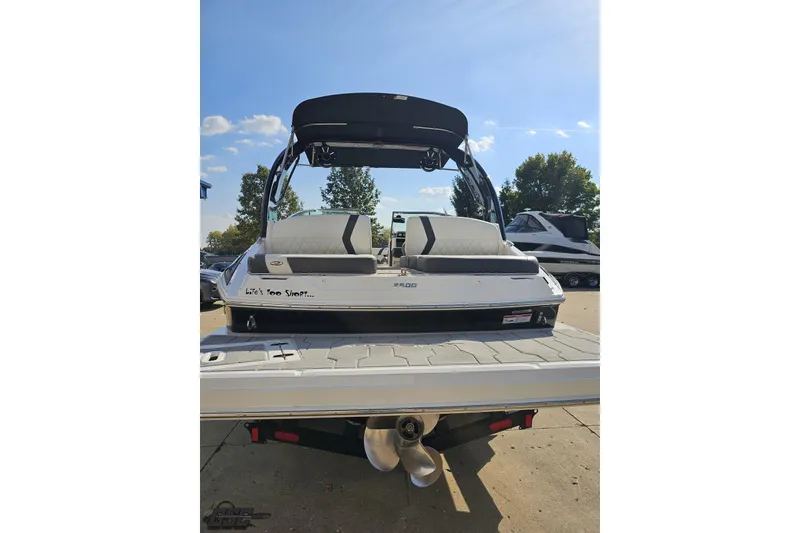 Slide: The Image of 2018 Regal 2500 Bowrider boat with swim platform, parked outdoors under clear sky. - 32