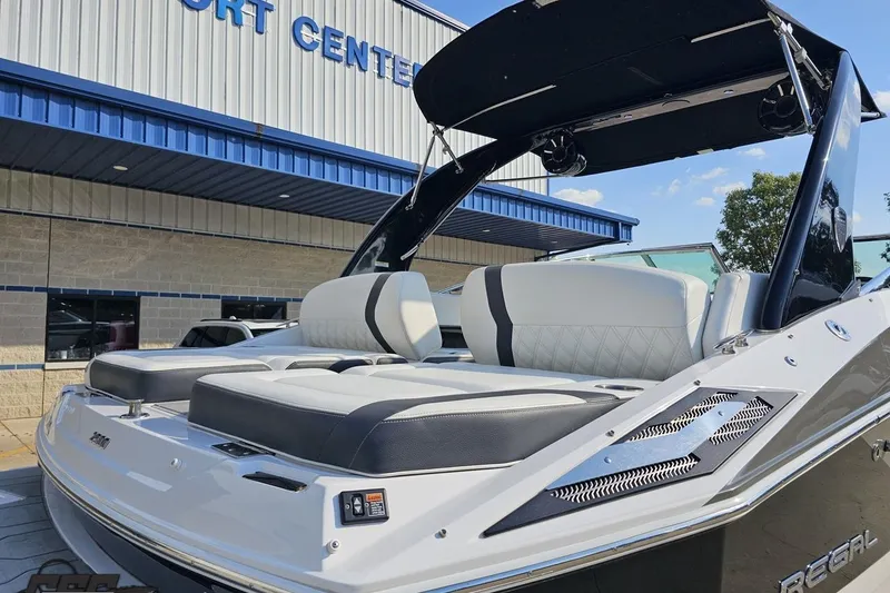 Slide: The Image of 2018 Regal 2500 Bowrider boat displayed at a marine center, featuring sleek seating. - 33