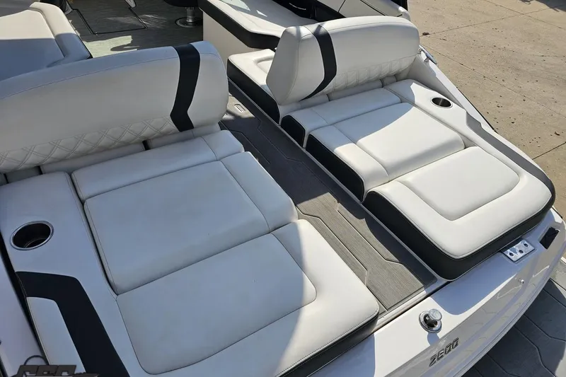 Slide: The Image of 2018 Regal 2500 Bowrider boat with luxurious white seating and cup holders. - 35