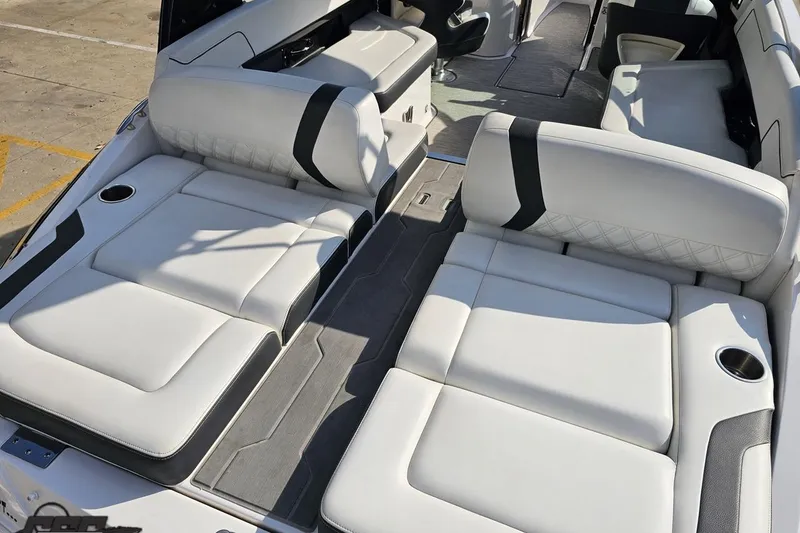 Slide: The Image of 2018 Regal 2500 Bowrider boat interior with white cushioned seating and cup holders. - 38