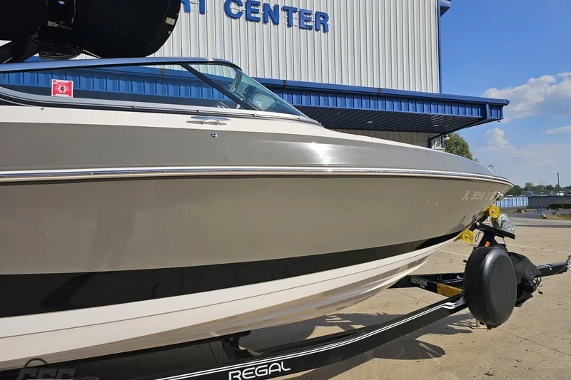 Slide: The Image of 2018 Regal 2500 Bowrider boat on trailer outside a marine center. - 4