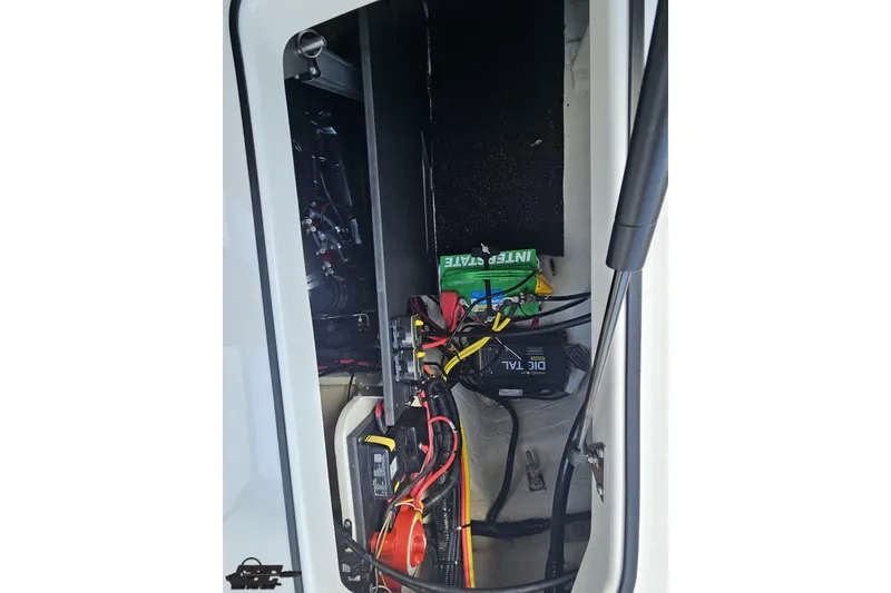 Slide: The Image of 2018 Regal 2500 Bowrider battery compartment with wiring and components. - 45