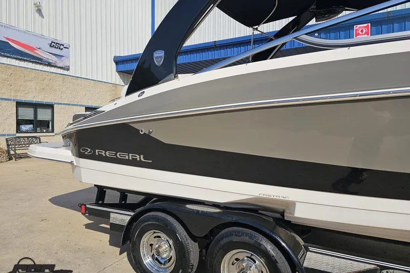 Slide: The Image of 2018 Regal 2500 Bowrider boat on trailer outside a building. - 5