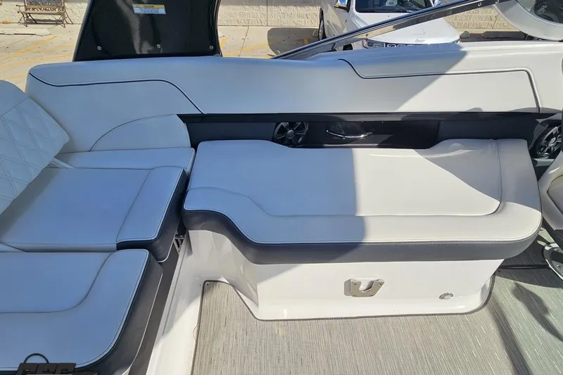 Slide: The Image of 2018 Regal 2500 Bowrider interior seating with white upholstery and storage compartment. - 57