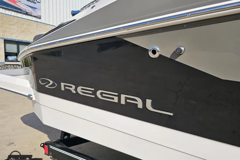 Slide: The Image of 2018 Regal 2500 Bowrider boat, close-up of sleek black and white exterior design. - 6