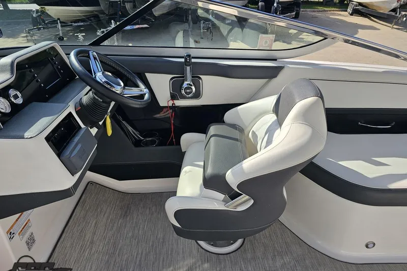 Slide: The Image of 2018 Regal 2500 Bowrider cockpit with steering wheel and comfortable seating. - 65