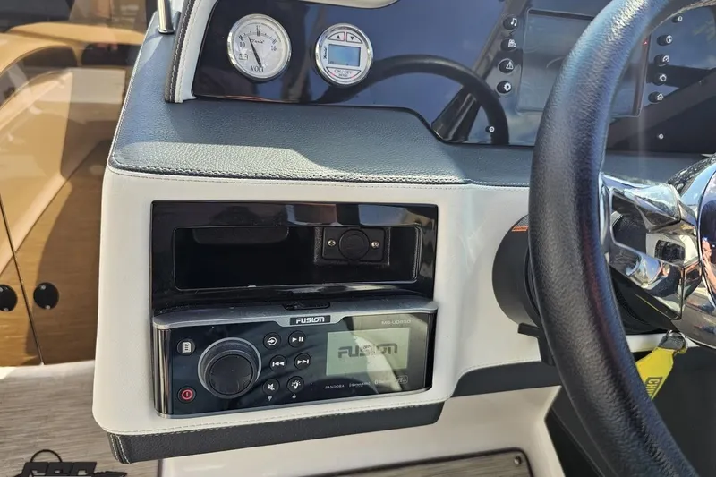 Slide: The Image of Dashboard of a 2018 Regal 2500 Bowrider with steering wheel and audio controls. - 69