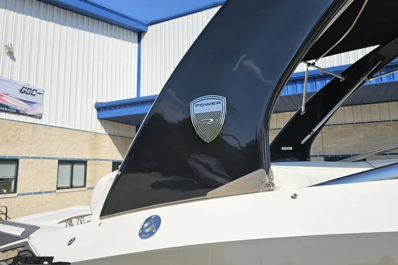 Slide: The Image of 2018 Regal 2500 Bowrider boat with Power Tower feature, docked near a building. - 7