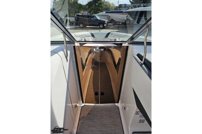 Slide: The Image of Interior view of a 2018 Regal 2500 Bowrider boat with open cabin door. - 76