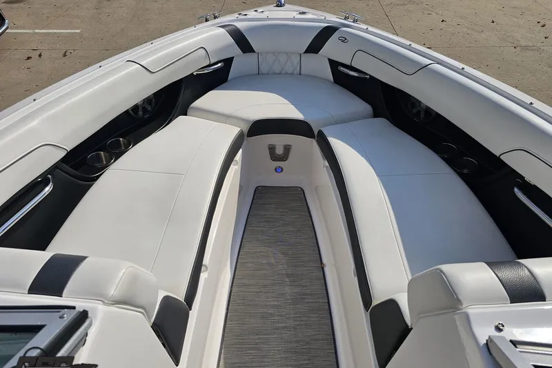 Slide: The Image of 2018 Regal 2500 Bowrider interior with white seating and cup holders. - 77