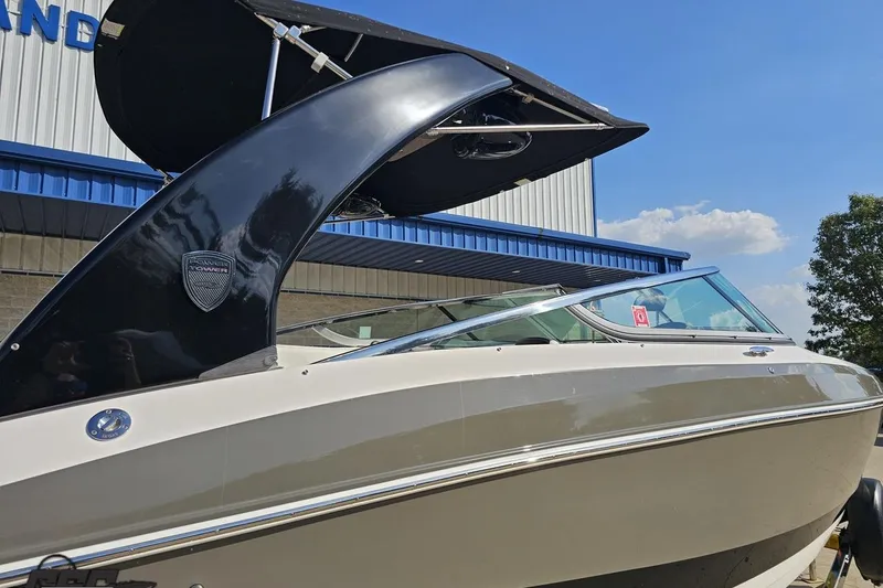 Slide: The Image of 2018 Regal 2500 Bowrider boat with sleek design and black canopy. - 8
