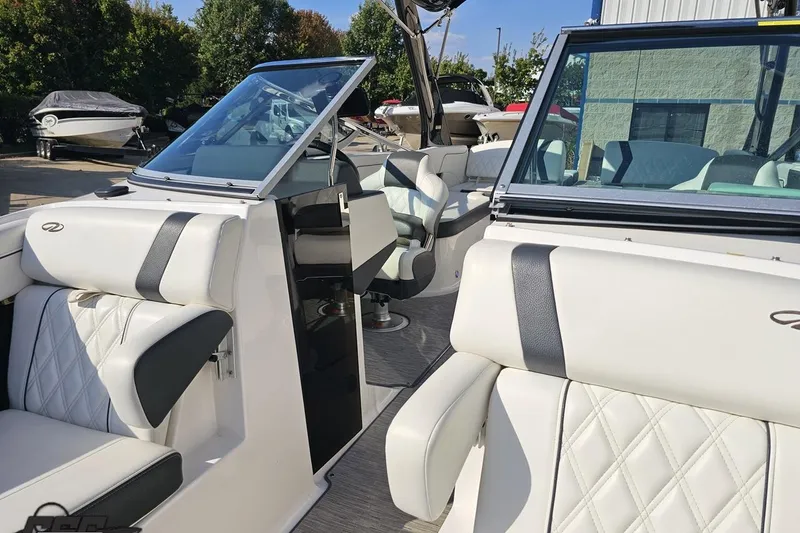 Slide: The Image of 2018 Regal 2500 Bowrider boat interior with white leather seating and open cockpit. - 82