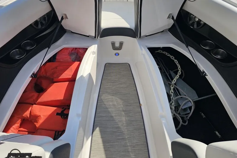 Slide: The Image of 2018 Regal 2500 Bowrider interior with life jackets and anchor storage. - 83