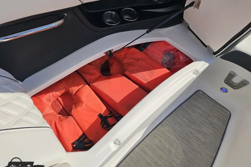 Slide: The Image of Storage compartment with life jackets in a 2018 Regal 2500 Bowrider boat. - 84