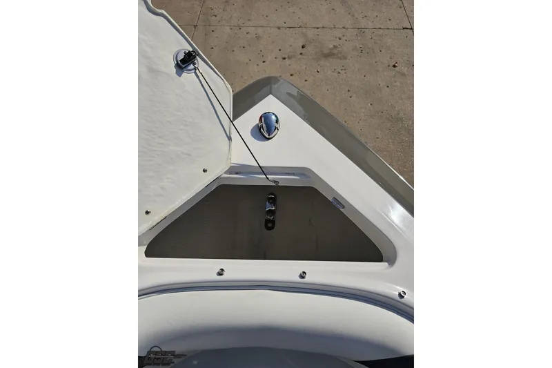 Slide: The Image of 2018 Regal 2500 Bowrider boat anchor compartment, open lid, showing storage space. - 86