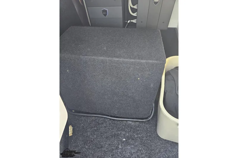 Slide: The Image of 2018 Regal 2500 Bowrider interior with carpeted storage compartment and wiring. - 88