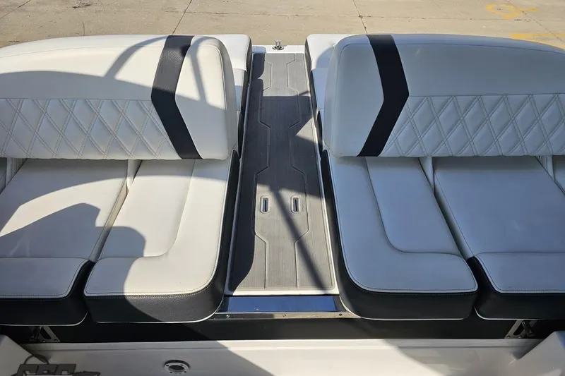 Slide: The Image of 2018 Regal 2500 Bowrider boat interior with white cushioned seating and black accents. - 94