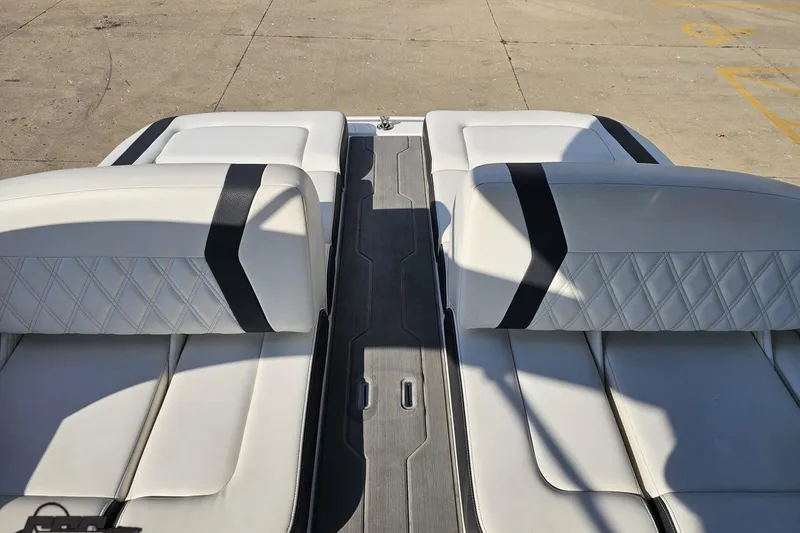 Slide: The Image of 2018 Regal 2500 Bowrider boat interior with white leather seats and black accents. - 95