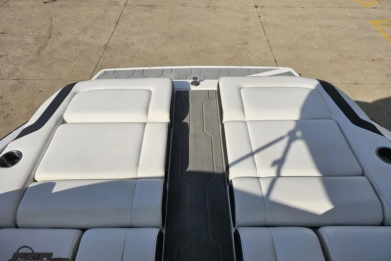 Slide: The Image of 2018 Regal 2500 Bowrider boat with white cushioned seating and sleek design. - 98