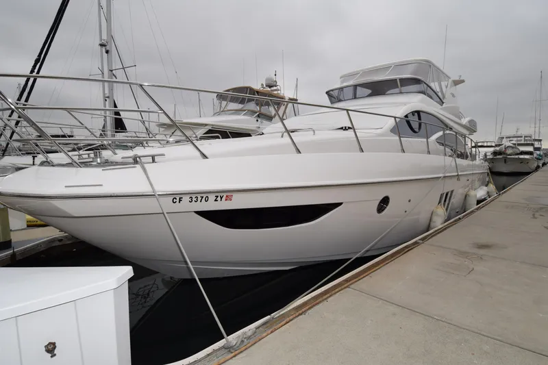 The Image of 2010 Azimut 58 yacht docked at marina, showcasing sleek design and modern features. - 0