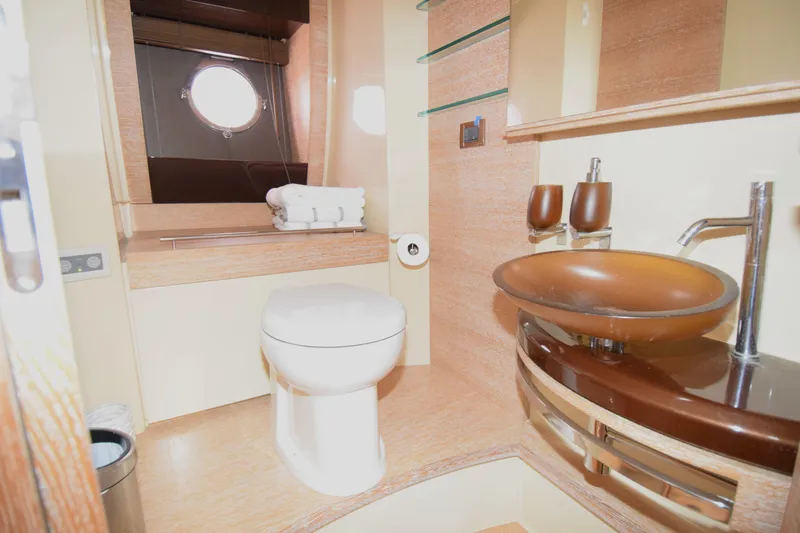 Slide: The Image of Luxurious bathroom in 2010 Azimut 58 yacht with modern fixtures and porthole window. - 13