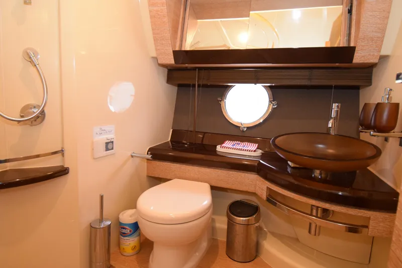 Slide: The Image of Luxurious bathroom in 2010 Azimut 58 yacht with modern fixtures and porthole window. - 17
