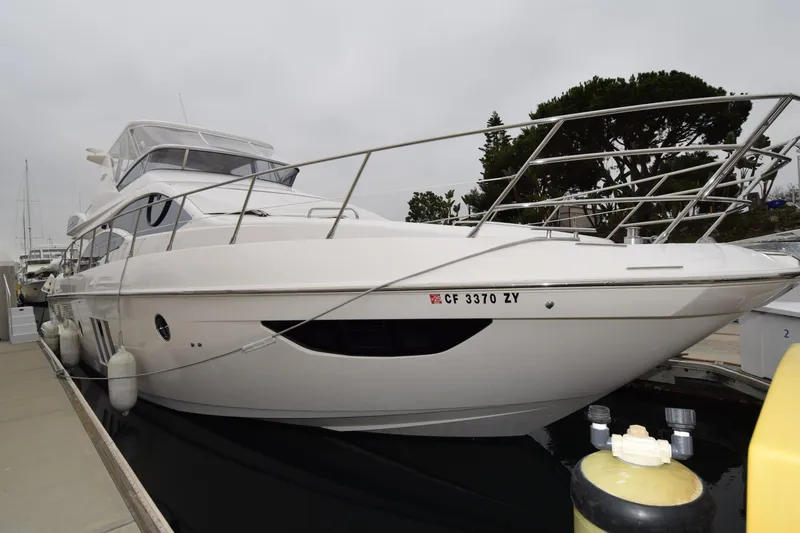 Slide: The Image of 2010 Azimut 58 yacht docked at marina, showcasing sleek design and modern features. - 29