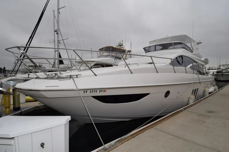 Slide: The Image of 2010 Azimut 58 yacht docked at marina under cloudy skies. - 30