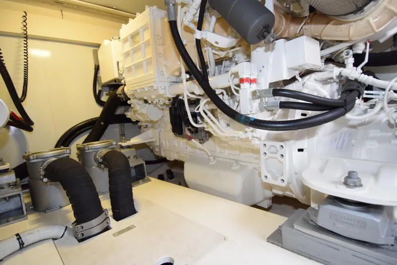 Slide: The Image of Engine room of a 2010 Azimut 58 yacht, showcasing mechanical components and hoses. - 32
