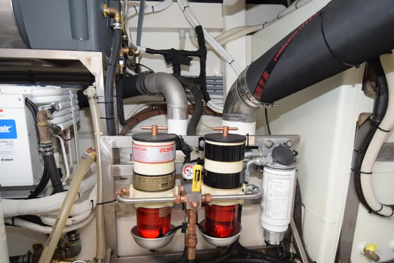 Slide: The Image of Engine room of a 2010 Azimut 58 yacht, featuring fuel filters and piping. - 35