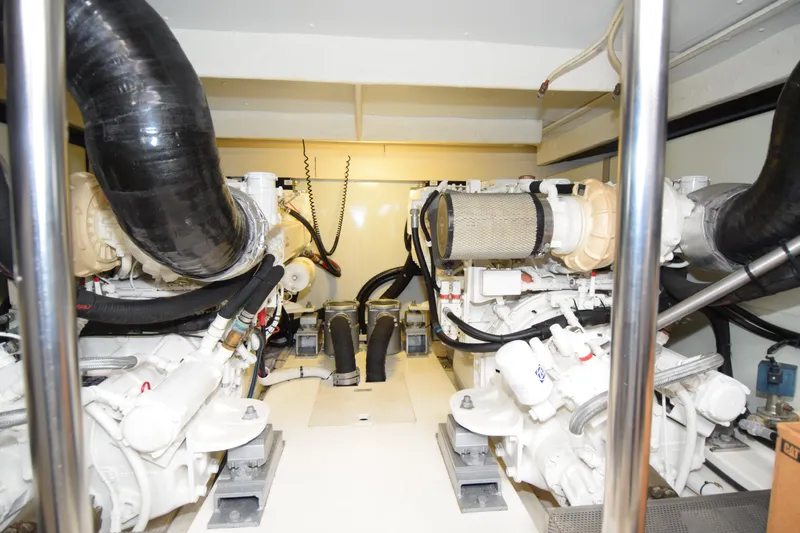 Slide: The Image of Engine room of a 2010 Azimut 58 yacht, showcasing dual engines and mechanical components. - 36