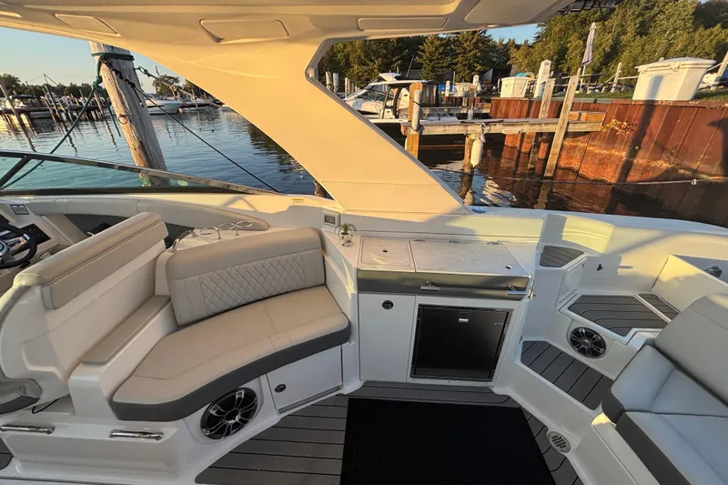 Slide: The Image of 2022 Searay SLX350 boat interior with seating and dock view. - 12