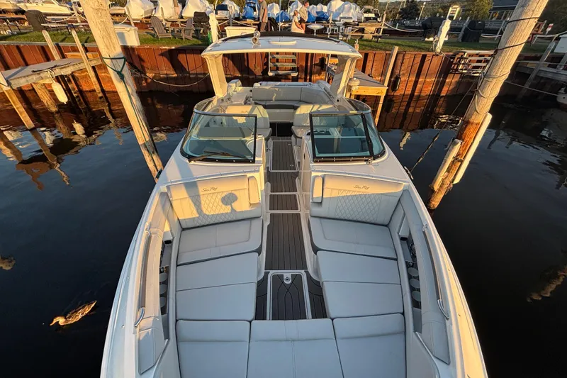 Slide: The Image of 2022 Searay SLX350 boat docked, featuring spacious seating and elegant design. - 18
