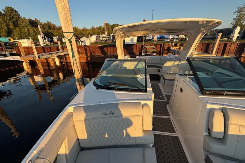 Slide: The Image of 2022 Searay SLX350 boat docked, featuring spacious seating and sleek design. - 20