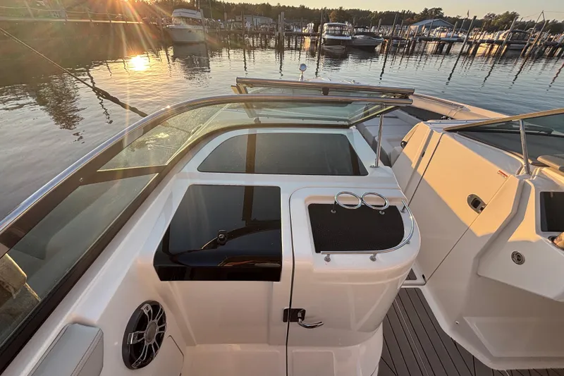 Slide: The Image of 2022 Searay SLX350 boat interior at sunset, docked in a marina. - 22