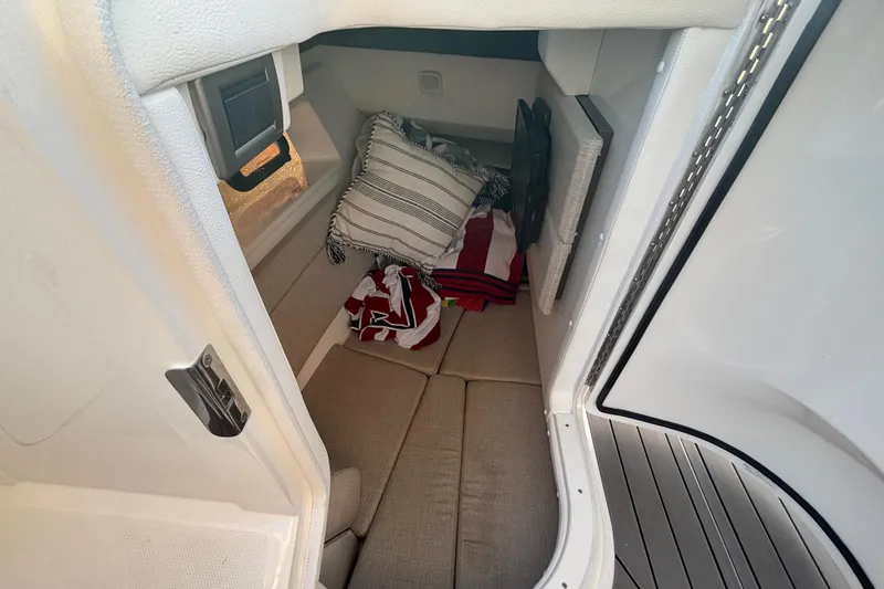 Slide: The Image of 2022 Searay SLX350 cabin interior with cushions and striped pillows. - 23