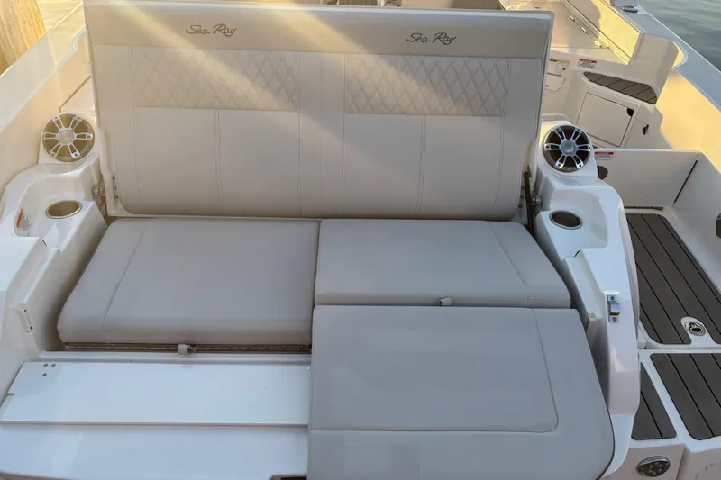 Slide: The Image of 2022 Searay SLX350 boat seating area with cup holders and speakers. - 27