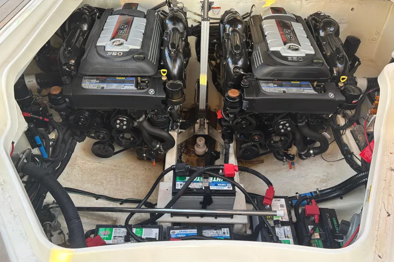Slide: The Image of 2022 Searay SLX350 engine compartment with dual engines and battery setup. - 28