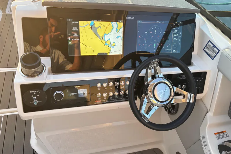 Slide: The Image of 2022 Searay SLX350 boat dashboard with navigation screens and controls. - 32