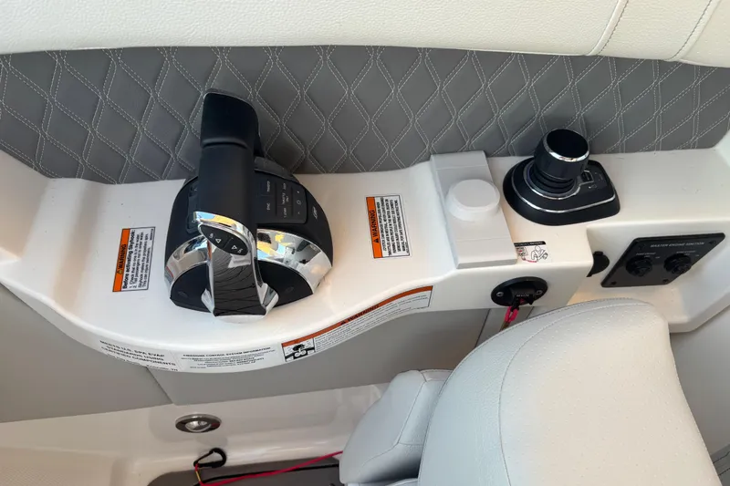 Slide: The Image of 2022 Searay SLX350 boat control panel with joystick and throttle. - 33