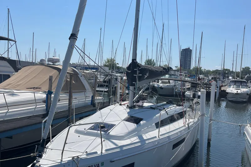 The Image of 2024 Jeanneau 380 sailboat docked in a marina under clear blue skies. - 0
