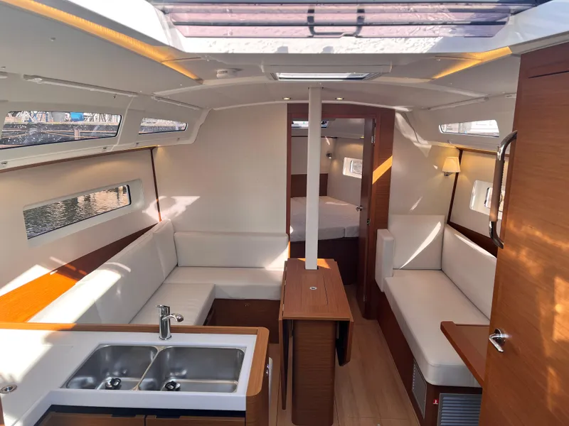 Slide: The Image of Luxurious interior of 2024 Jeanneau 380 yacht with modern seating and kitchen area. - 11