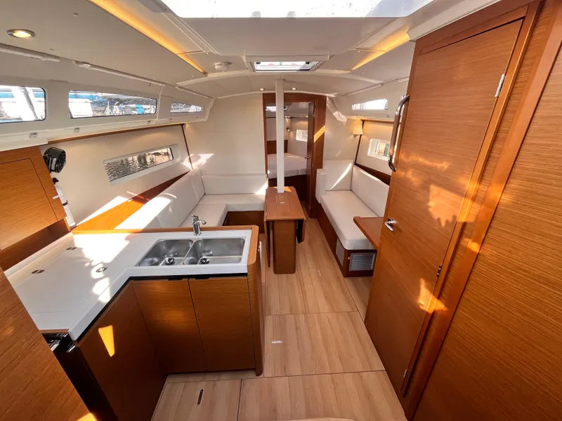 Slide: The Image of Interior of 2024 Jeanneau 380 yacht, featuring modern wood finishes and spacious layout. - 12